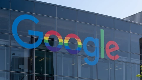 Google logo on the glass facade of a Googleplex building.