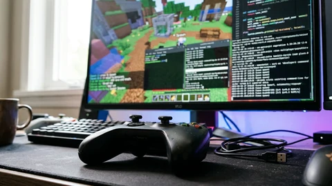 AI-generated image of a game controller and game world on a monitor.